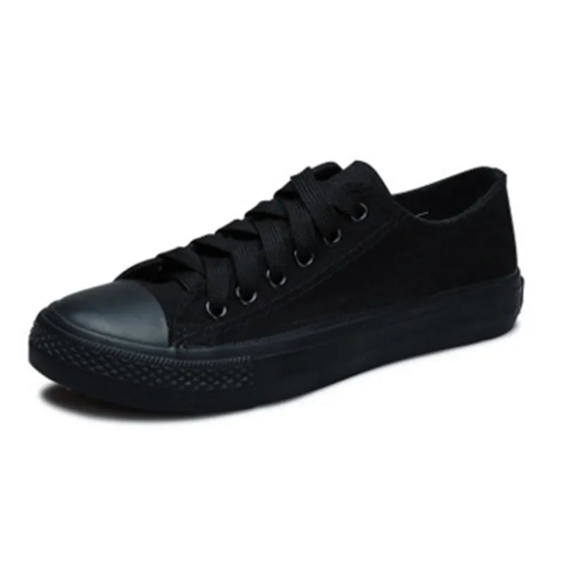 Women's solid-colour canvas lace-up shoes in black, shown on a neutral background.