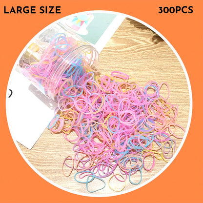 Multicoloured assortment of thin TPU elastic hair bands for babies and children in a reusable plastic container.