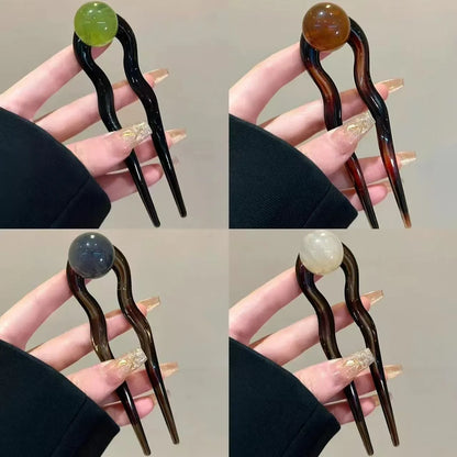 Acrylic U-shaped hair barrette with retro ball design in caramel colour