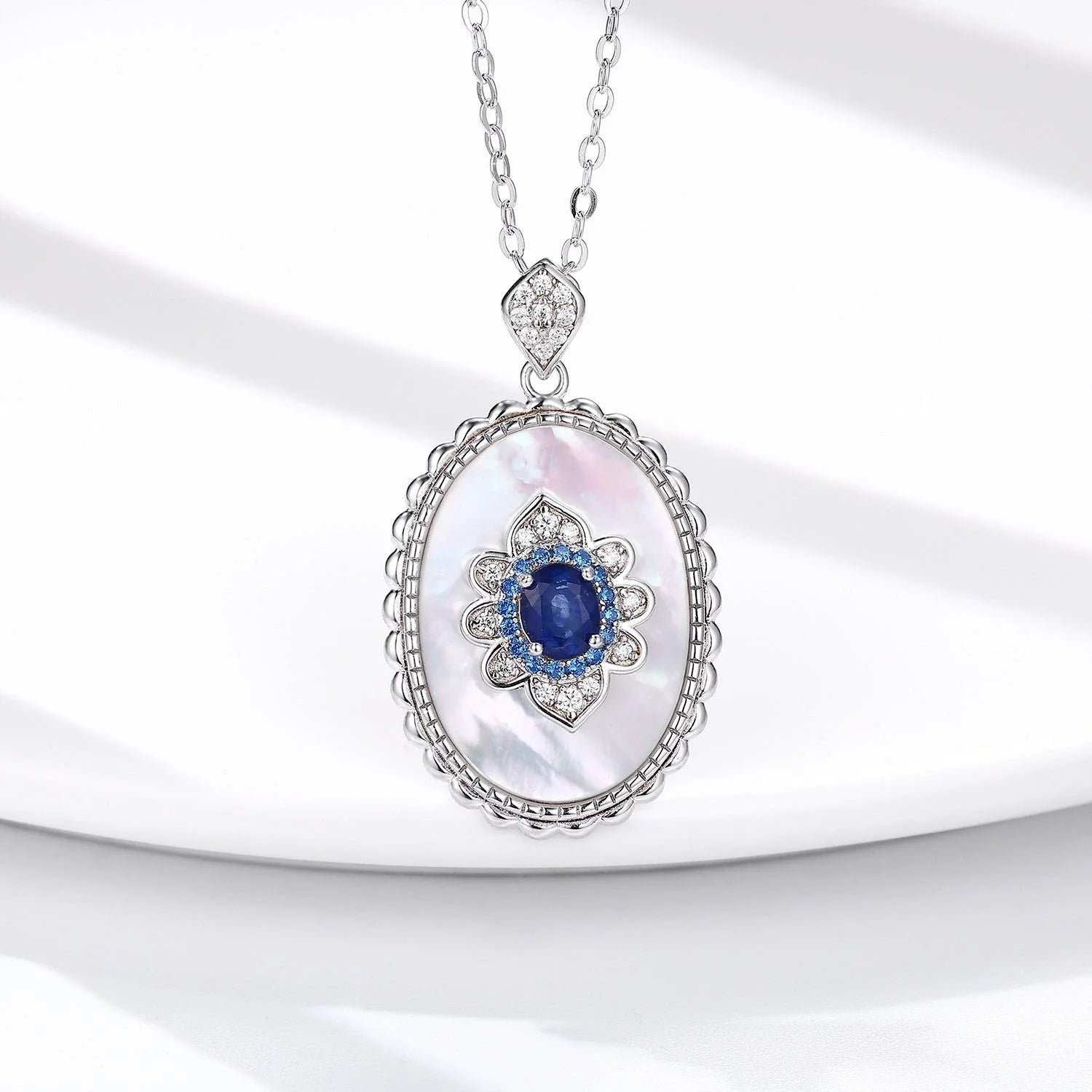 Elegant sapphire and diamond pendant necklace made of 925 sterling silver with a sleek geometric design and O-chain