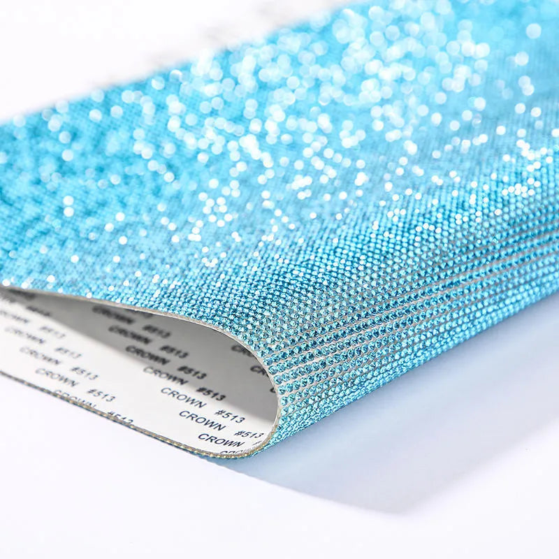 Rhinestone sticker net on backing sheet for hot drilling application to fabrics in multiple colour options