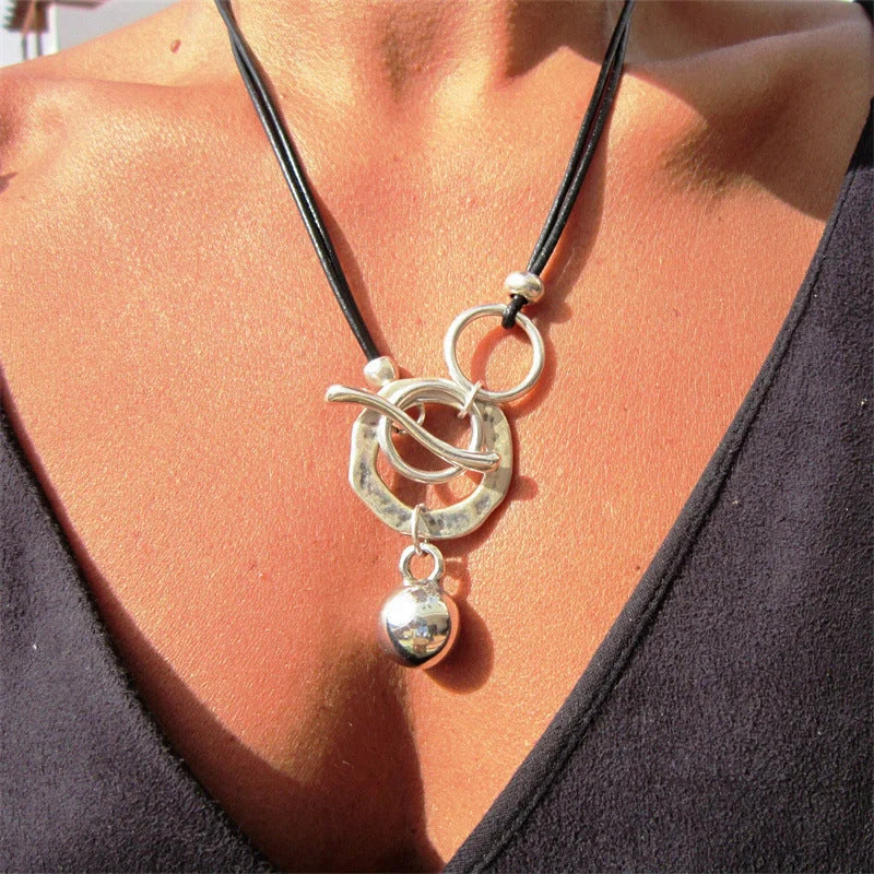 Stylish leather necklace with a boho-chic buckle detail, perfect for adding a touch of rustic charm to any outfit.