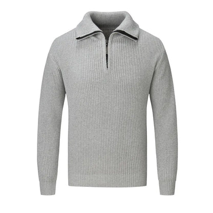 A man wearing a solid-colour slim-fit loose pullover sweater in a neutral colour.