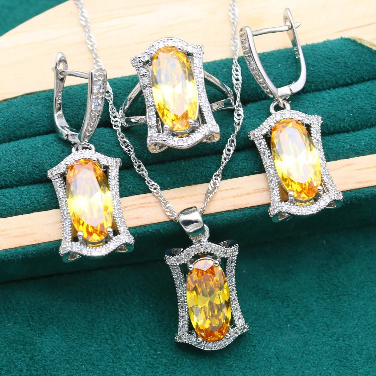 Women's yellow and olive alloy zircon jewellery set with necklace, earrings, ring, and bracelet on a snake bone chain.