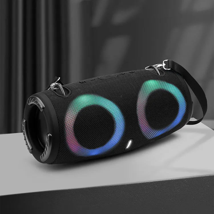 War Drum Bluetooth speaker in blue with RGB coloured lights, showing waterproof design and included strap for portable use