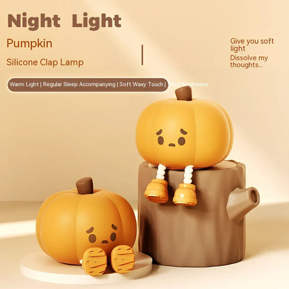 Orange silicone pumpkin night lamp measuring 98x105x83mm with built-in battery and USB charging port