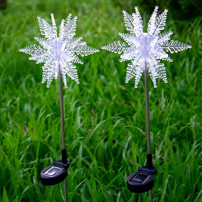 LED solar snowflake garden light with flower-shaped head, warm light, and 2V 100mA solar panel for outdoor lawn use