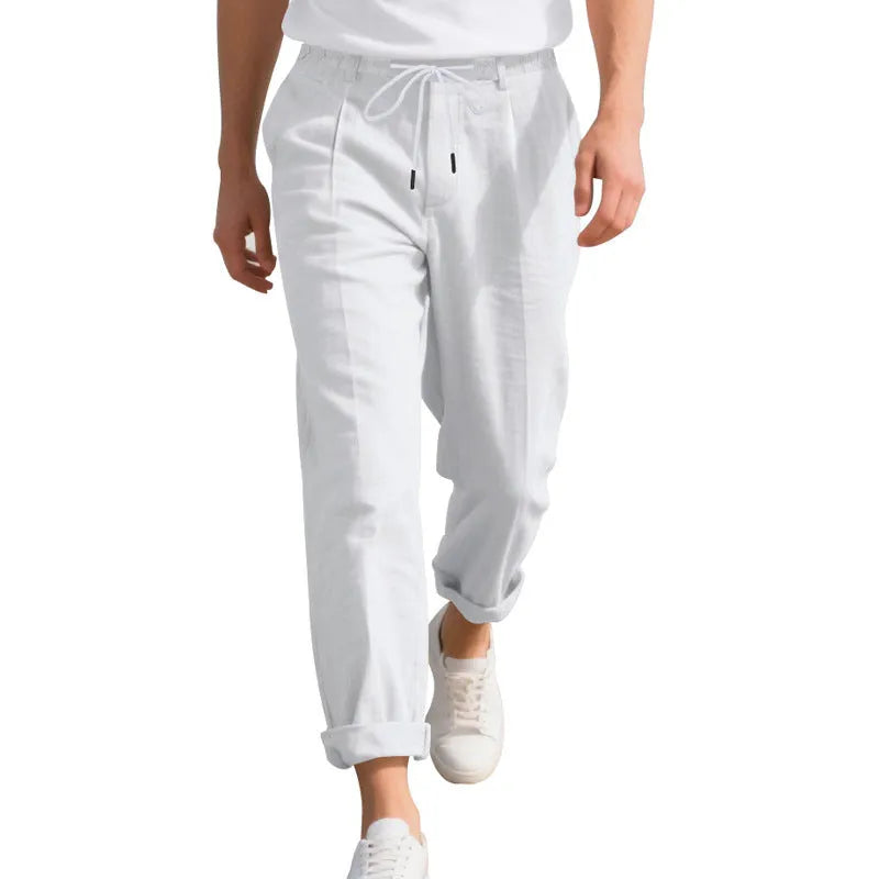 Men's light beige linen trousers with a loose straight leg and drawstring waist on a hanger.