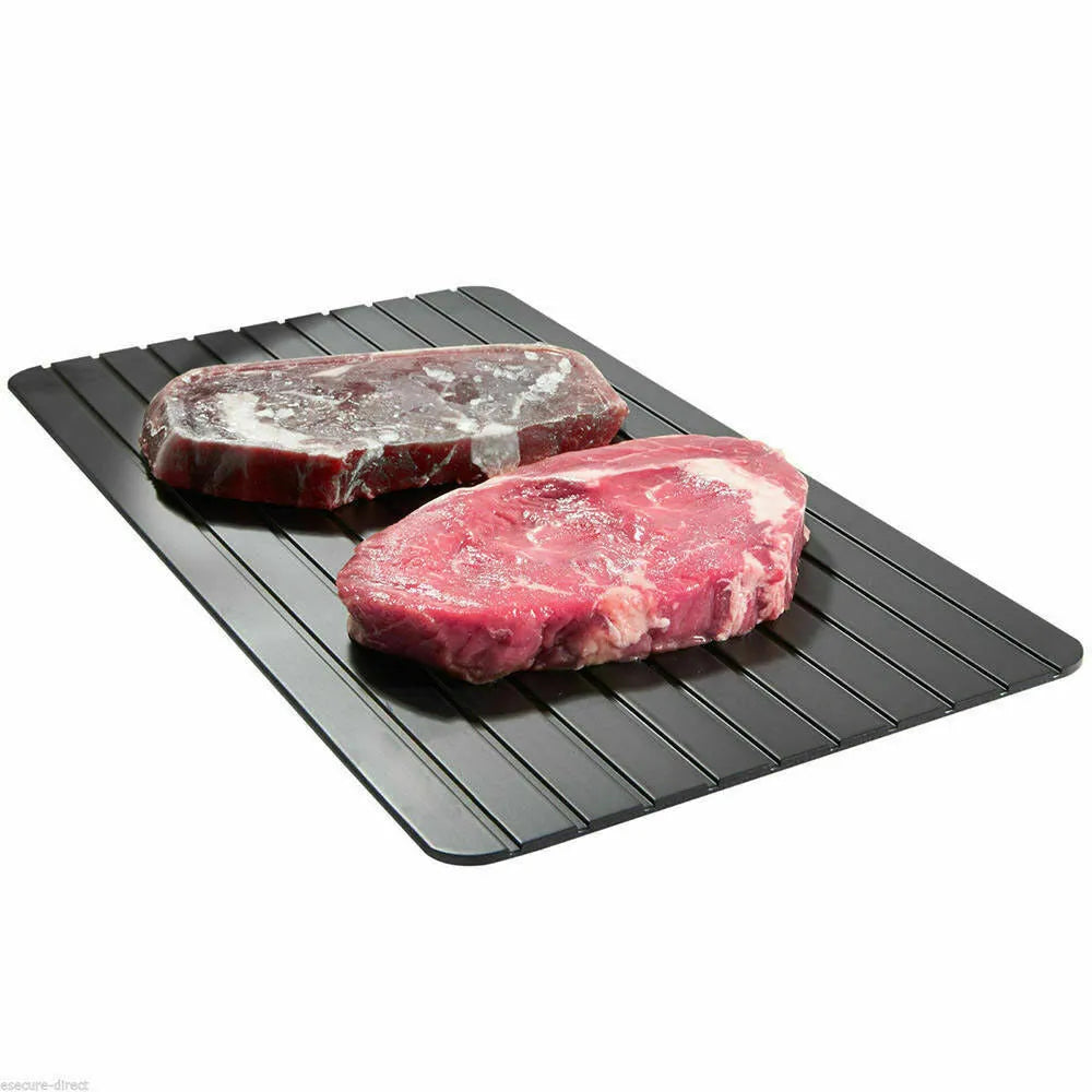Black aluminium fast defrosting tray for thawing frozen food on kitchen counter
