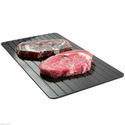 Black aluminium fast defrosting tray for thawing frozen food on kitchen counter