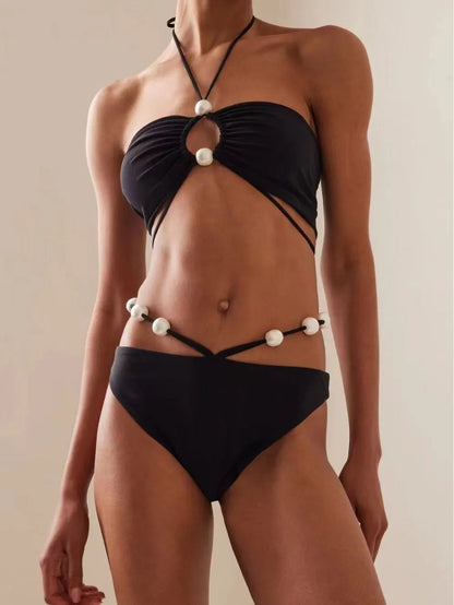 Women's black lace-up split bikini swimsuit with adjustable front and matching briefs