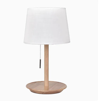 Walnut solid wood bedside lamp with fabric lampshade on wooden surface