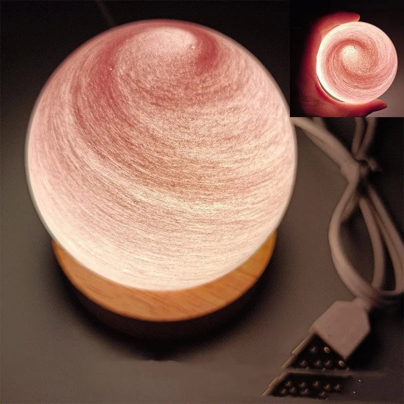 Planet-shaped USB night light with adjustable dimming in 12 colour options on its base.