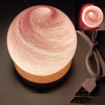 Planet-shaped USB night light with adjustable dimming in 12 colour options on its base.