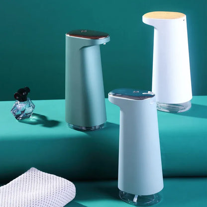 White automatic foam soap dispenser with infrared sensor on a bathroom countertop.