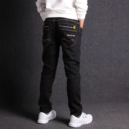 Boys' black micro-stretch cotton jeans showing 4-way flexibility and middle waist design