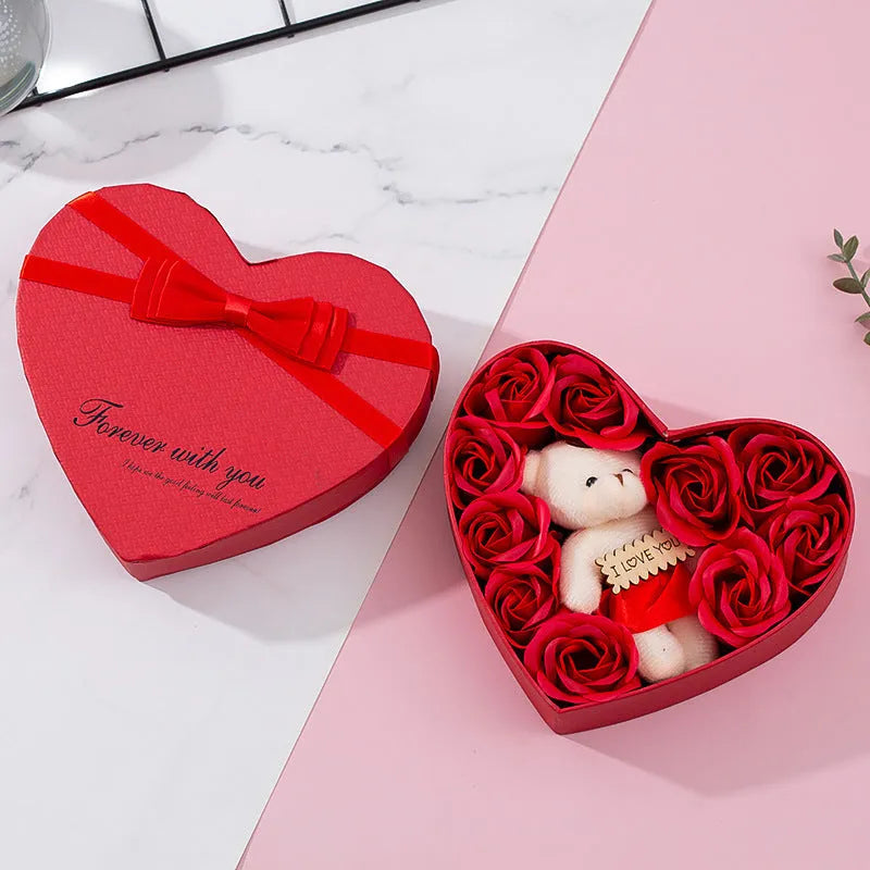 Red heart-shaped gift box open to reveal soap roses inside.
