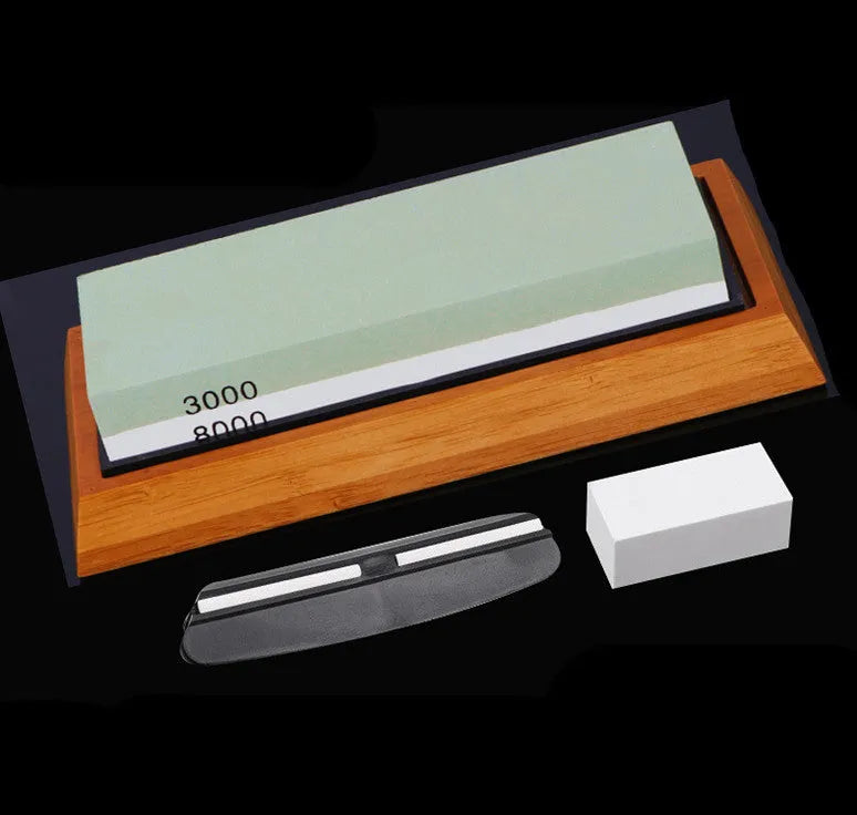 Green and white double-sided whetstone with bamboo base and sharpening accessories