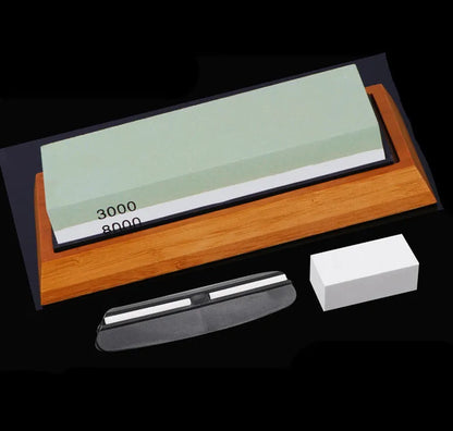 Green and white double-sided whetstone with bamboo base and sharpening accessories