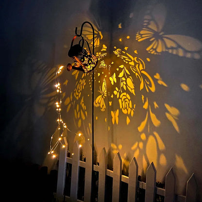 Solar-powered garden lamp with tapered butterfly pattern iron design and warm white LED light