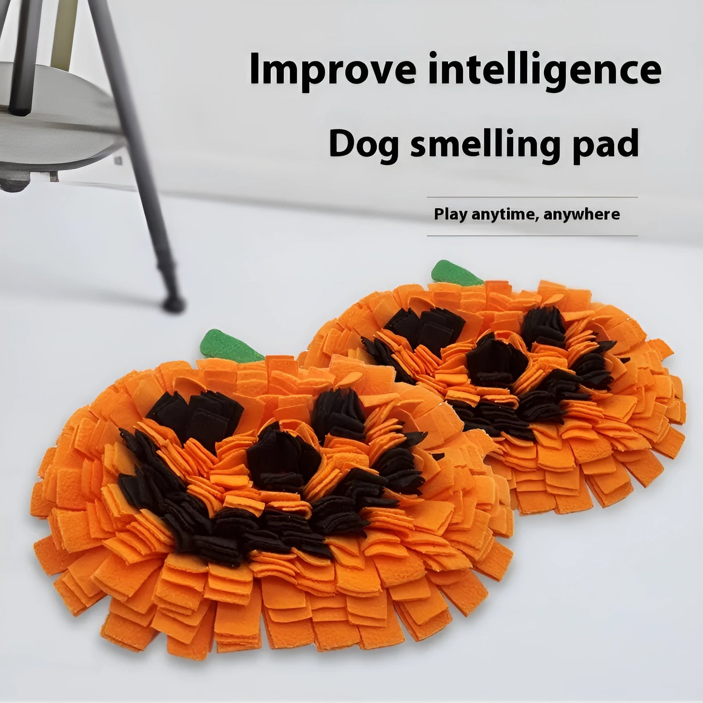 Orange pumpkin-shaped fleece pet slow feeder mat for dogs and cats on a wooden floor