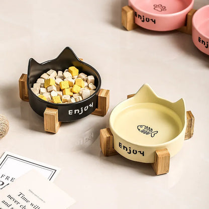 Porcelain cat bowl with anti-tumble wooden frame in pink with a cat paw design