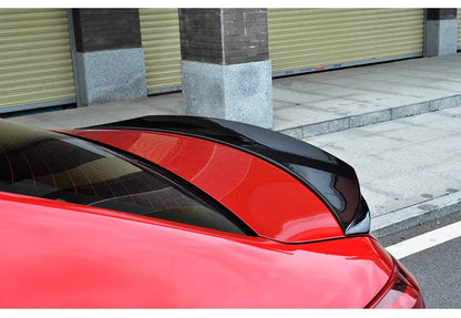 Mazda 3 Axela Exela tail trim in bright black with large fixed wind surround, showing precise fitment on vehicle rear