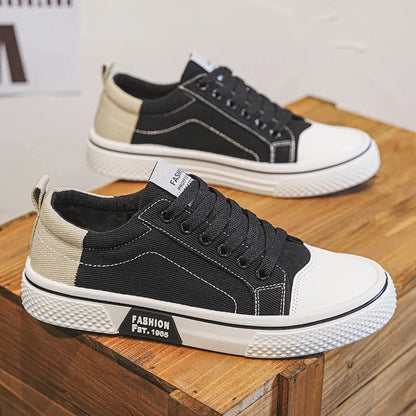 Men's low-top blue canvas skate shoes with round toe and flat heel on a white background.