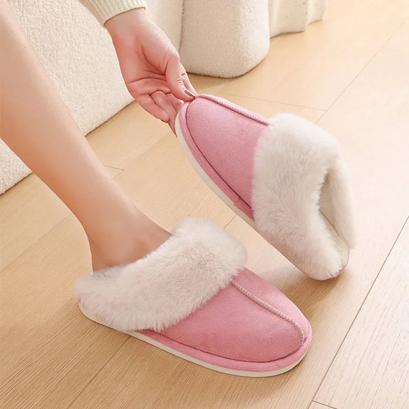 Women's plush indoor slippers in a selection of colours with a fuzzy upper and flat sole.