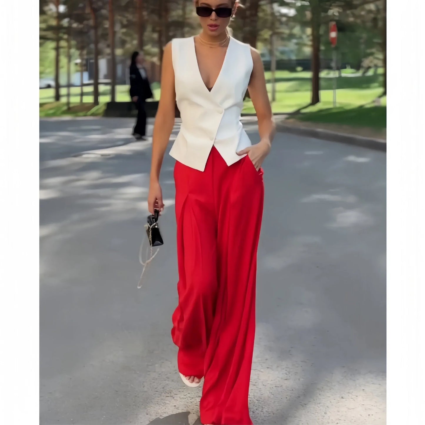 Beige women's two-piece set with sleeveless V-neck top and high-waist wide-leg trousers on a hanger.