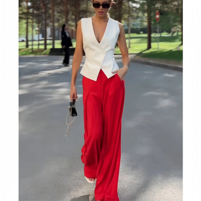 Beige women's two-piece set with sleeveless V-neck top and high-waist wide-leg trousers on a hanger.
