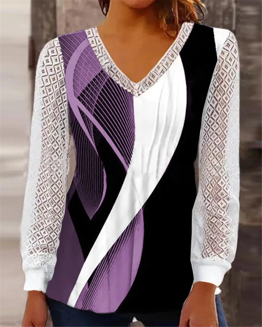Purple V-neck loose top with hollow-out lace print and long sleeves.