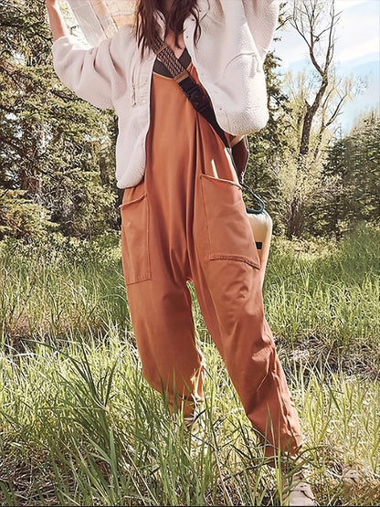 Sleeveless jumpsuit with spaghetti straps, pockets, and zipper closure in various colors