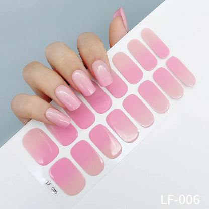 Sheet of 16 small design nail art stickers including cross, rose, tulip and marble patterns.