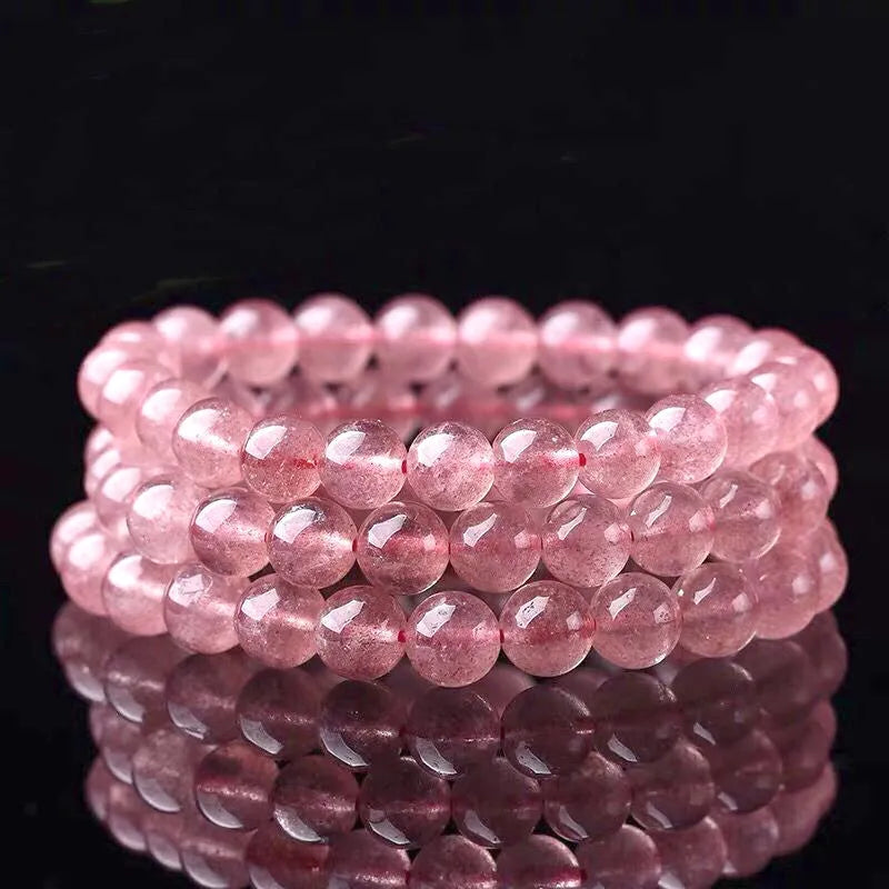 Women's strawberry quartz crystal bracelet with mixed 6mm, 8mm, and 10mm polished beads.