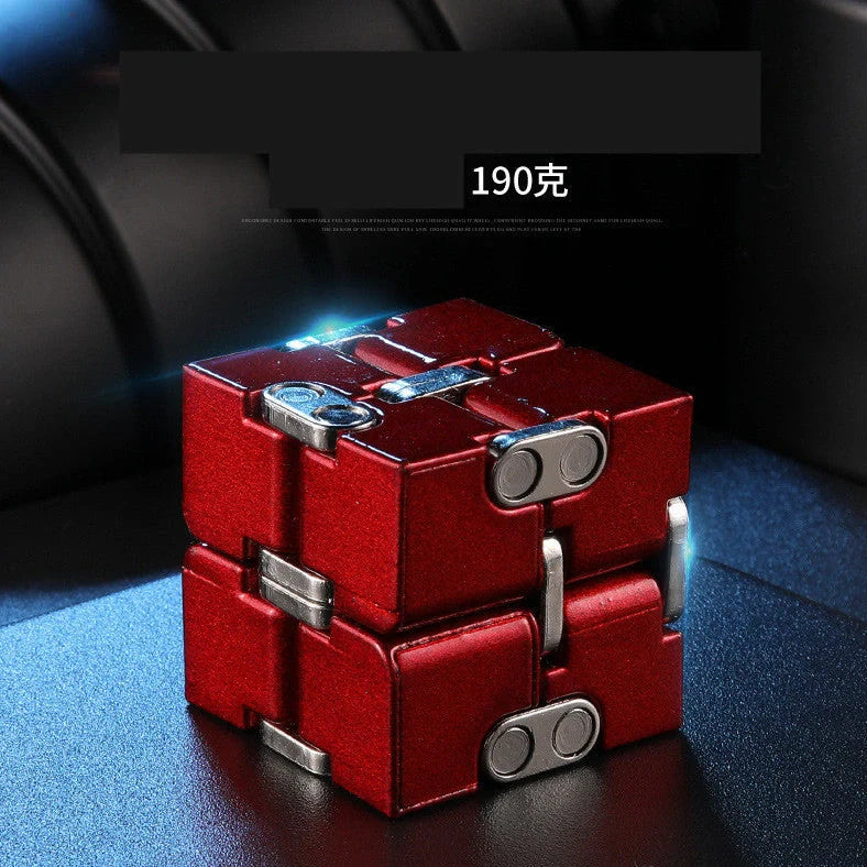 Zinc alloy Infinity Cube with eight rotating cubes showing black and silver colour options on wooden surface