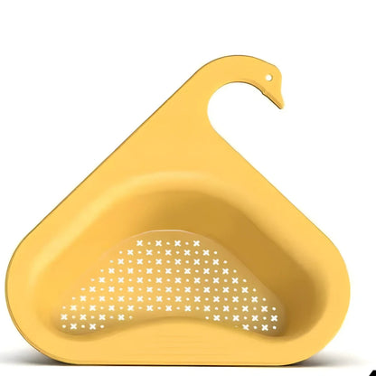 Yellow swan-shaped plastic kitchen drainer basket with drainage holes on kitchen counter