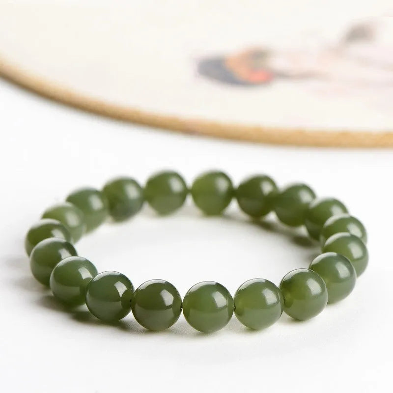 Hetian jade ball bracelet with polished spherical beads in ice-like clear water colours on wrist