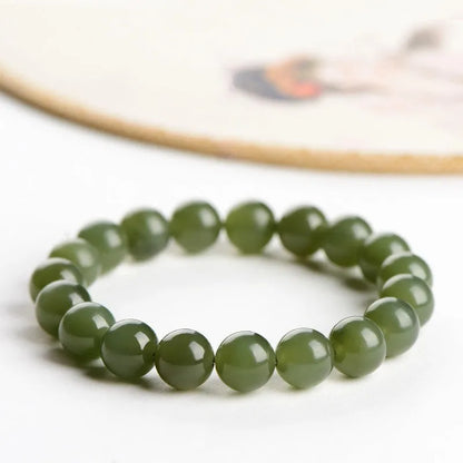 Hetian jade ball bracelet with polished spherical beads in ice-like clear water colours on wrist