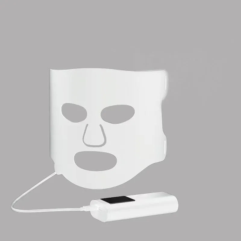 Black and white LED phototherapy face mask with controller showing seven colour light therapy options
