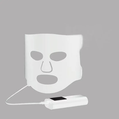 Black and white LED phototherapy face mask with controller showing seven colour light therapy options