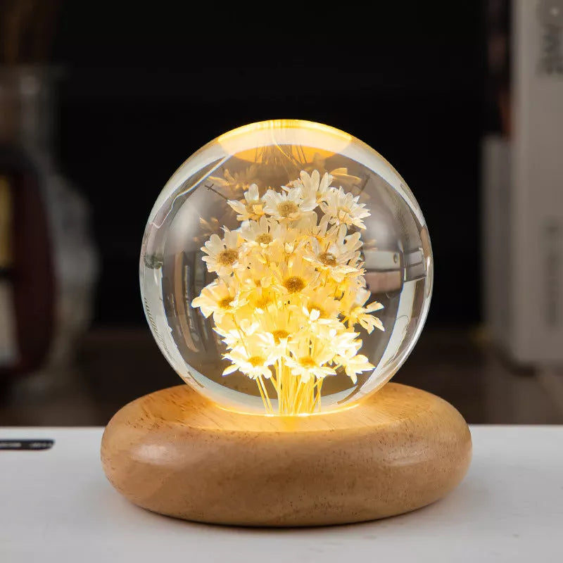 LED Dandelion Crystal Ball Night Light with oak base emitting soft glow