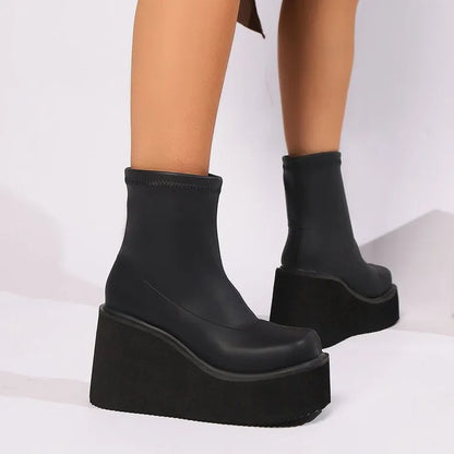 Plus size women's black wedge heel boots with round toe and waterproof platform sole.