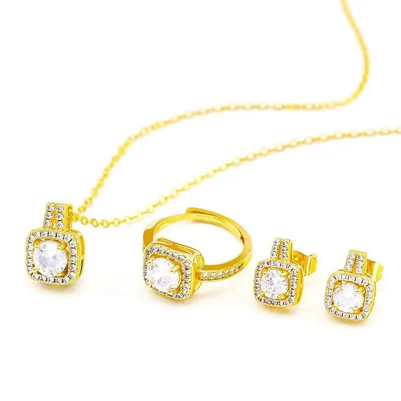 Elegant gold-toned jewelry set including necklace, earrings, and ring with zircon gemstone pendant