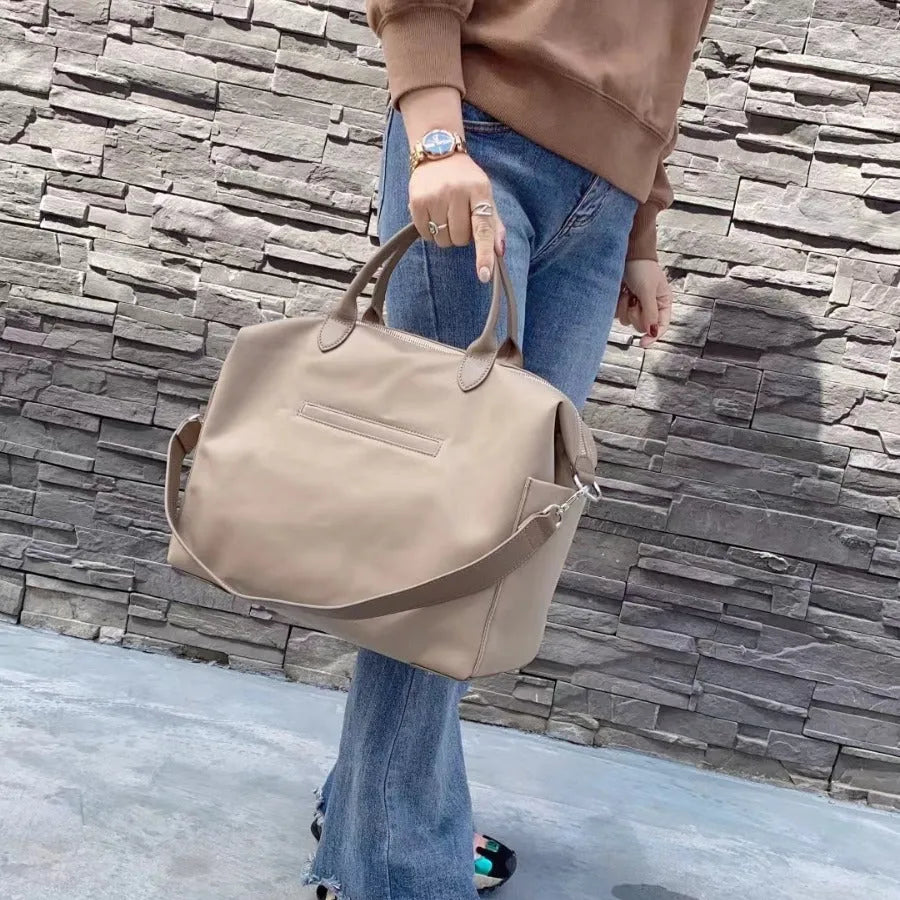 Nylon waterproof cloth shoulder bag with leather details in black or light khaki colour, 35x14x27cm dimensions