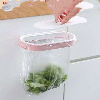 Blue or pink plastic kitchen garbage bag storage rack mounted on a cabinet or bench for organising carrier bags