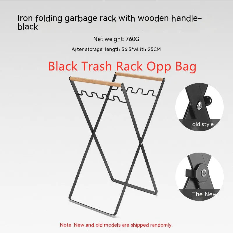 Black iron folding trash rack with wooden handles mounted on a wall holding a recycling bag.