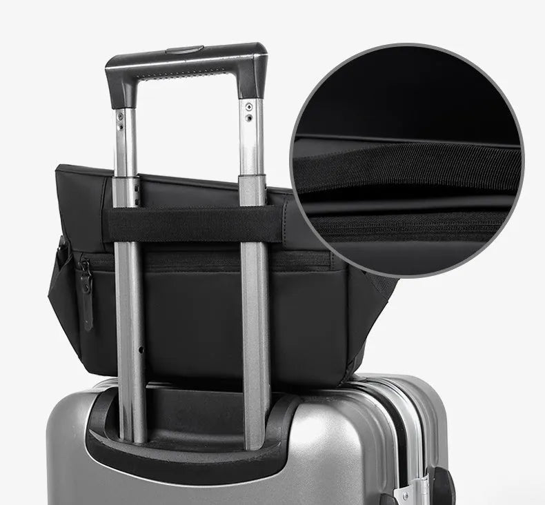 Grey crossbody bag with single shoulder strap showing zipper opening and internal organisation pockets