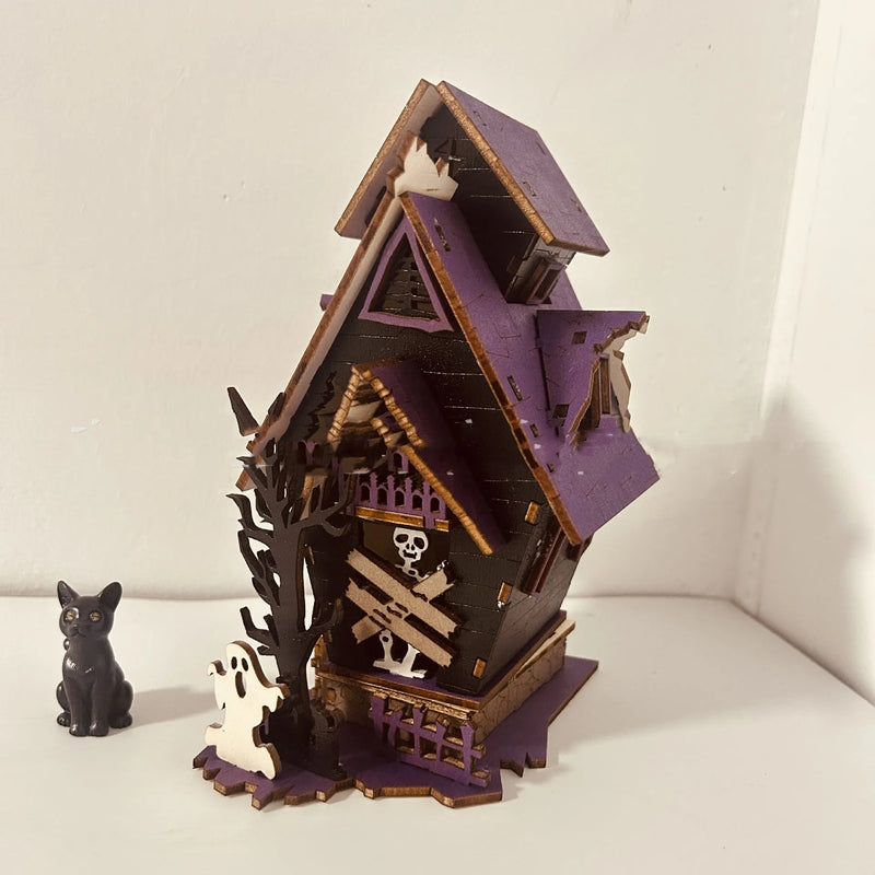 Halloween DIY Wooden Glowing Haunted House Table Decoration: A 14x10.5x19cm wooden craft kit for creating a luminous centrepiece without lights, doubling as a candlestick holder.