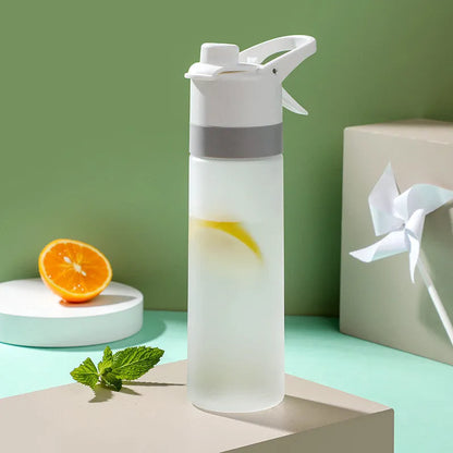 Large plastic spray water bottle with handle strap and leakproof lid in green colour.